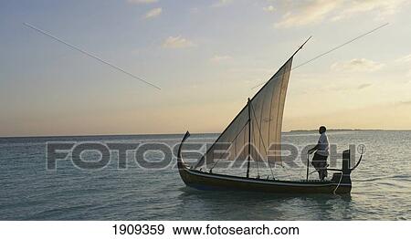 Stock Photo - Traditional Dhoni Fishing Boat, Soneva Fushi, Northern Atoll, Maldives. Fotosearch