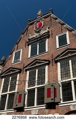 Traditional Dutch building with coat of arms of Amsterdam at top, three white crosses on black and red; Holland View Large Photo Image Stock Photograph - Traditional Dutch building with coat of arms of Amsterdam at top, three white crosses on black and red; Holland. Fotosearch