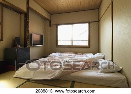 Stock Image - Traditional Japanese Bedroom With Tatami Floor And Futon Beds; Takayama, Gifu, Japan. Fotosearch