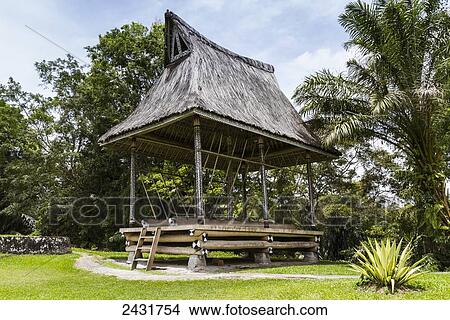 Picture - Traditional Karo Batak rice pounding house (Siwaluh Jabu) in the compound of the Simalungan Batak chiefs, Rumah Bolon, North Sumatra, Indonesia. Fotosearch
