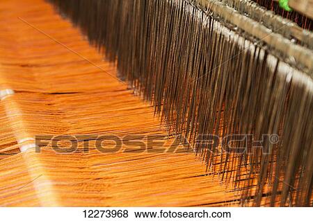 Traditional Lurik cloth being woven on a loom in a lurik workshop in Cawas village, Klaten, Central Java, Indonesia View Large Photo Image Stock Photo - Traditional Lurik cloth being woven on a loom in a lurik workshop in Cawas village, Klaten, Central Java, Indonesia. Fotosearch