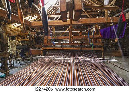 Stock Photography - Traditional Lurik cloth being woven on a loom in a lurik workshop in Cawas village, Klaten, Central Java, Indonesia. Fotosearch
