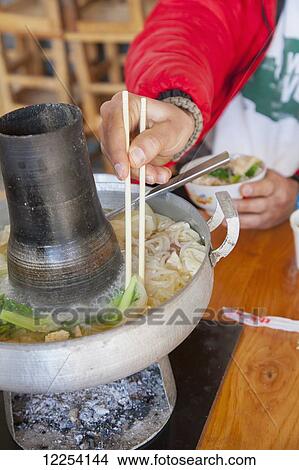 Picture - Traditional Naxi Hot Pot; Lijiang, Yunnan Province, China. Fotosearch