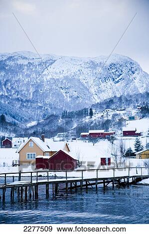 Traditional Norwegian village in the snow, jetty at side of fjord; Ortnevik, Sognefjord, Norway View Large Photo Image Stock Photo - Traditional Norwegian village in the snow, jetty at side of fjord; Ortnevik, Sognefjord, Norway. Fotosearch
