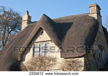 Stock Image - Traditional Thatched Cottage; Wiltshire, England. Fotosearch