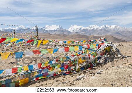 Traditional Tibetan flags on the mountain, Himalayas in the background, Tibetan Friendship Highway; Tibet, China View Large Photo Image Stock Image - Traditional Tibetan flags on the mountain, Himalayas in the background, Tibetan Friendship Highway; Tibet, China. Fotosearch