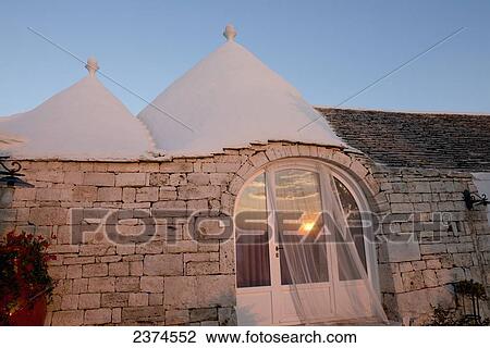 Stock Image - Traditional trulli at La Rosa dei Quattro Venti yoga retreat; Puglia, Italy. Fotosearch