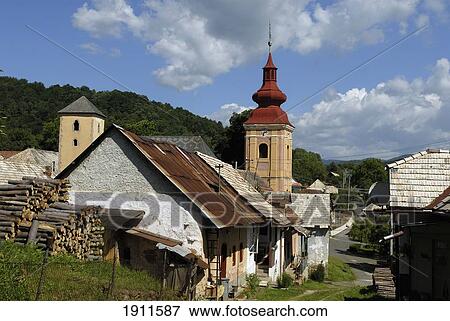 Stock Photo - Traditional Village Cottages And Church, Slovakia. Fotosearch