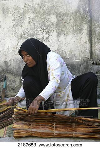 Stock Image - Traditional village life on an island; Maldives. Fotosearch