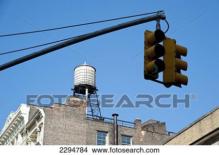 Traditional Water Deposit And Traffic Light In Manhattan, New York, Usa View Large Photo Image Picture - Traditional Water Deposit And Traffic Light In Manhattan, New York, Usa. Fotosearch
