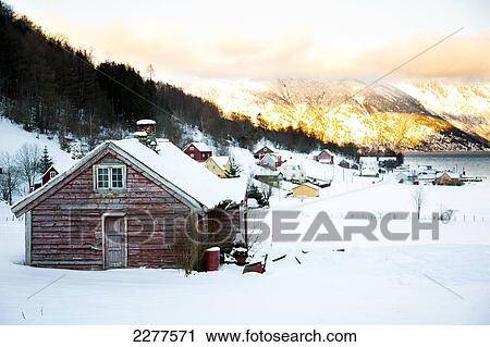 Traditonal red wooden building in the village, Fjord and mountains, with sun setting over the mountains; Ortnevik, Sognefjord, Norway View Large Photo Image Stock Image - Traditonal red wooden building in the village, Fjord and mountains, with sun setting over the mountains; Ortnevik, Sognefjord, Norway. Fotosearch