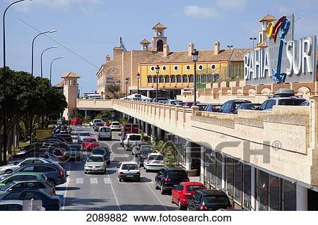 Stock Image - Traffic And Parked Cars On A Busy Road; Bahia Sur, San Fernando, Andalusia, Spain. Fotosearch