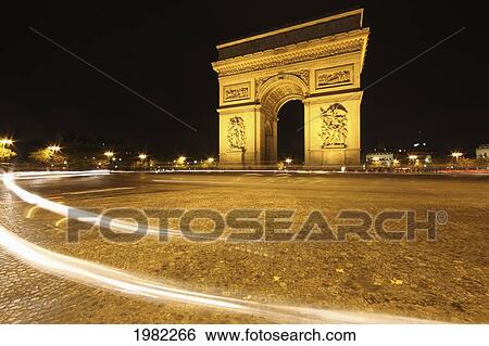 Stock Photograph - Traffic Light Trails Around The Arc De Triomphe; Paris France. Fotosearch