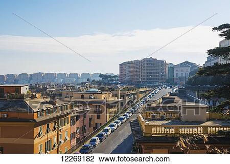 Traffic lines the road in a cityscape; Genoa, Liguria, Italy View Large Photo Image Stock Image - Traffic lines the road in a cityscape; Genoa, Liguria, Italy. Fotosearch