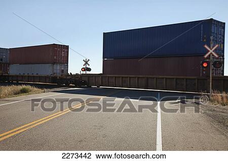 Stock Image - Train going through crossing; webb saskatchewan canada. Fotosearch