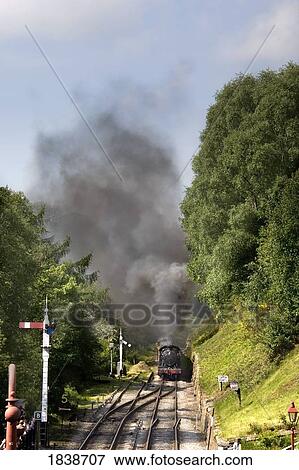 Train In Motion; Goathland, North Yorkshire, England, Uk View Large Photo Image Stock Photo - Train In Motion; Goathland, North Yorkshire, England, Uk. Fotosearch