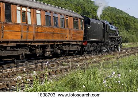 Stock Image - Train In Motion; Levisham, North Yorkshire, England, Uk. Fotosearch