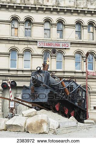 Stock Image - Train sculpture in front of the Steampunk HQ; Oamaru, South Island, New Zealand. Fotosearch