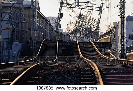 Stock Photography - Train Tracks And Electricity Poles Damaged After Earthquake. Fotosearch