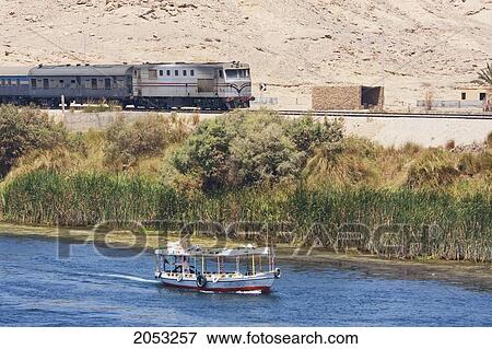 Train Travelling Along The Nile River Between Aswan And Edfu, Aswan, Egypt View Large Photo Image Stock Photo - Train Travelling Along The Nile River Between Aswan And Edfu, Aswan, Egypt. Fotosearch