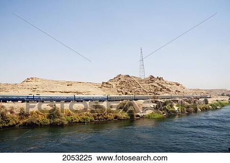 Train Travelling Along The Nile River Between Aswan And Edfu, Aswan, Egypt View Large Photo Image Stock Photography - Train Travelling Along The Nile River Between Aswan And Edfu, Aswan, Egypt. Fotosearch