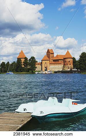 Stock Photography - Trakai Island Castle with paddle boat in foreground; Trakai, Lithuania. Fotosearch