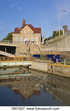 Stock Photo - Tranquil Scene Of Erie Canal Locks And Old City Hall; Lockport, New York, Usa. Fotosearch