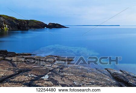 Tranquil water along the coastline of Orkney Islands at dusk; Orkney, Scotland View Large Photo Image Stock Image - Tranquil water along the coastline of Orkney Islands at dusk; Orkney, Scotland. Fotosearch
