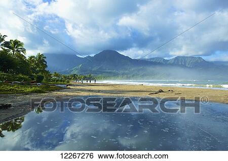 Tranquil water reflects rain clouds along the coast, Hanalei Bay; Kauai, Hawaii, United States of America View Large Photo Image Stock Photograph - Tranquil water reflects rain clouds along the coast, Hanalei Bay; Kauai, Hawaii, United States of America. Fotosearch