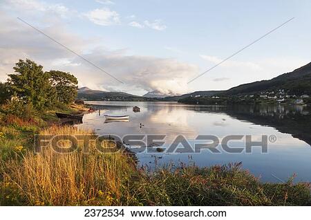 Picture - Tranquil waters reflecting the clouds and landscape; Skye, Scotland. Fotosearch