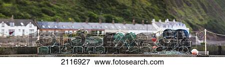 Traps Piled On The Shore With Houses In The Background; Burnmouth Scottish Borders Scotland View Large Photo Image Stock Photo - Traps Piled On The Shore With Houses In The Background; Burnmouth Scottish Borders Scotland. Fotosearch