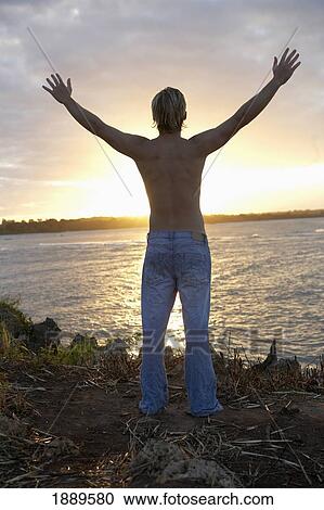 Traveler With Arms Raised To Setting Sun View Large Photo Image Stock Image - Traveler With Arms Raised To Setting Sun. Fotosearch