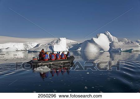 Stock Photograph - Travelers Pass Gigantic Icebergs In Wilhelmina Bay Off Enterprise Island In The Antarctic Peninsula. Fotosearch