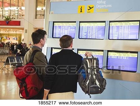 Travellers Studying Flight Departure Screens, Costa Del Sol, Malaga, Spain View Large Photo Image Stock Photo - Travellers Studying Flight Departure Screens, Costa Del Sol, Malaga, Spain. Fotosearch