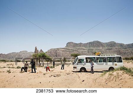 Stock Image - Travellers with their bus stuck in the sand near the Gheralta plateau; Tigray region, Ethiopia. Fotosearch