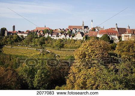 Trees And Buildings Against A Blue Sky; Rothenburg Ob Der Tauber Bavaria Germany View Large Photo Image Stock Image - Trees And Buildings Against A Blue Sky; Rothenburg Ob Der Tauber Bavaria Germany. Fotosearch