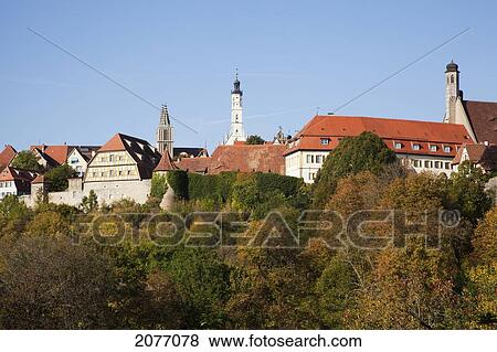 Trees And Buildings Against A Blue Sky; Rothenburg Ob Der Tauber Bavaria Germany View Large Photo Image Stock Photo - Trees And Buildings Against A Blue Sky; Rothenburg Ob Der Tauber Bavaria Germany. Fotosearch