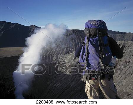 Treker With Backpack In Front Of Mount Bromo, Java, Indonesia View Large Photo Image Stock Photo - Treker With Backpack In Front Of Mount Bromo, Java, Indonesia. Fotosearch