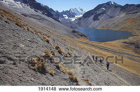Stock Photo - Trekkers Walking Down To Glacial Lake. Fotosearch