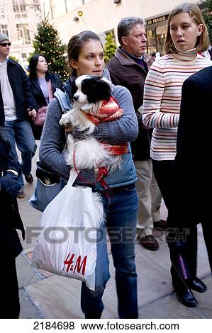 Stock Photo - Trendy Girl Carrying Tiny Dog And H&M Shopping Bag, Shopping Nyc. Fotosearch