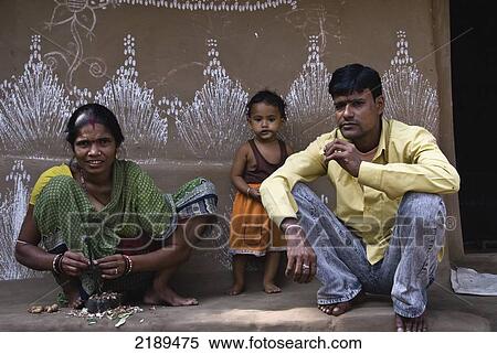 Stock Photography - Tribal Family Outside Their Home In Orissa With Wall Paintings, Raghurajpur, India. Fotosearch