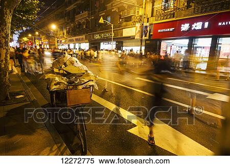 Tricycle laden with bags on East Nanjing Road at night, Shanghai, China View Large Photo Image Stock Photography - Tricycle laden with bags on East Nanjing Road at night, Shanghai, China. Fotosearch