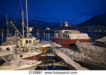 Stock Image - Tromso harbour at night; Tromso, Norway. Fotosearch