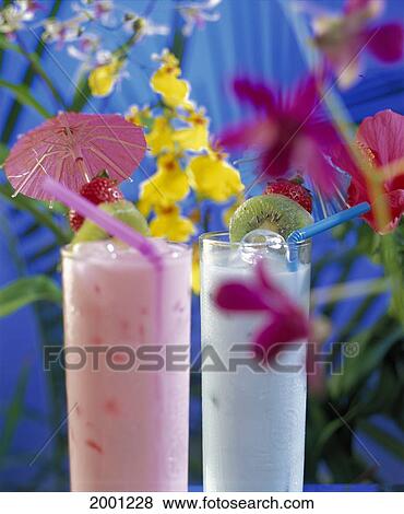 Tropical Fruit Drinks With Orchid Plants Background, Slices Of Fruit Garnish Umbrella View Large Photo Image Stock Photo - Tropical Fruit Drinks With Orchid Plants Background, Slices Of Fruit Garnish Umbrella. Fotosearch