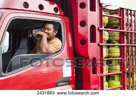 Truck driver smoking a cigarette in a truck with gas containers on board the car ferry between Parapat and Samosir Island, Lake Toba, North Sumatra, Indonesia View Large Photo Image Stock Image - Truck driver smoking a cigarette in a truck with gas containers on board the car ferry between Parapat and Samosir Island, Lake Toba, North Sumatra, Indonesia. Fotosearch