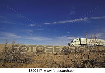 Stock Photo - Truck Driving Through Mojave Desert. Fotosearch
