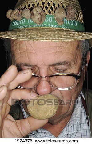 Stock Photograph - Truffle Hunter Smells Truffle. Fotosearch