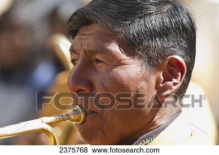 Stock Photo - Trumpet player of a brass band in a Preste procession through the streets of La Paz, Bolivia. Fotosearch