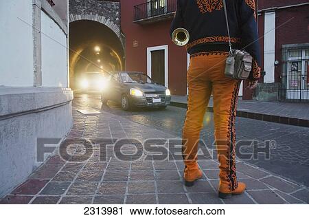 Trumpet player wearing orange mariachi outfit; Guanajuato, Guanajuato, Mexico View Large Photo Image Stock Image - Trumpet player wearing orange mariachi outfit; Guanajuato, Guanajuato, Mexico. Fotosearch
