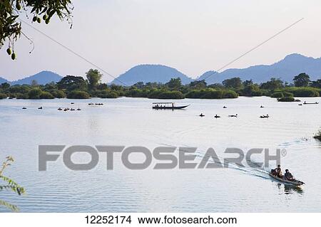 Tubing and boating around the islands on the Mekong River; Si Phan Don, Laos View Large Photo Image Picture - Tubing and boating around the islands on the Mekong River; Si Phan Don, Laos. Fotosearch